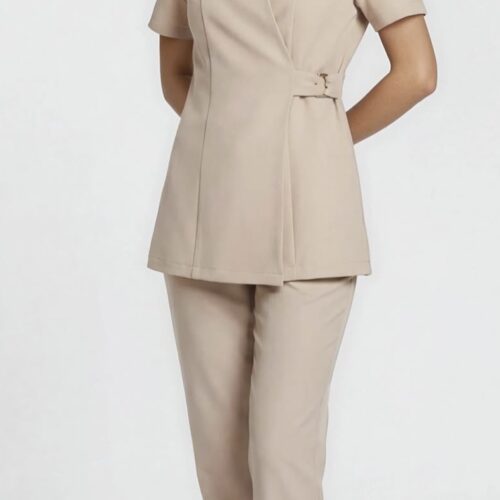 Beige spa uniform set with wrap-style tunic, side buckle detailing, and straight-fit pants