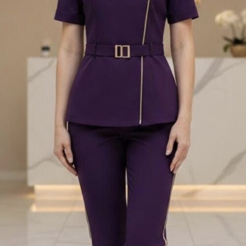 Purple spa uniform set with mandarin collar, front zip detailing, waist belt, and slim-fit pants