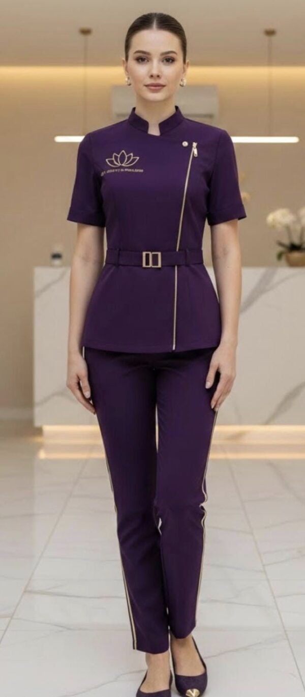 Purple spa uniform set with mandarin collar, front zip detailing, waist belt, and slim-fit pants