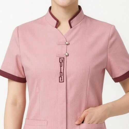 Pink spa uniform with mandarin collar, contrast sleeve trim, and front pocket detailing