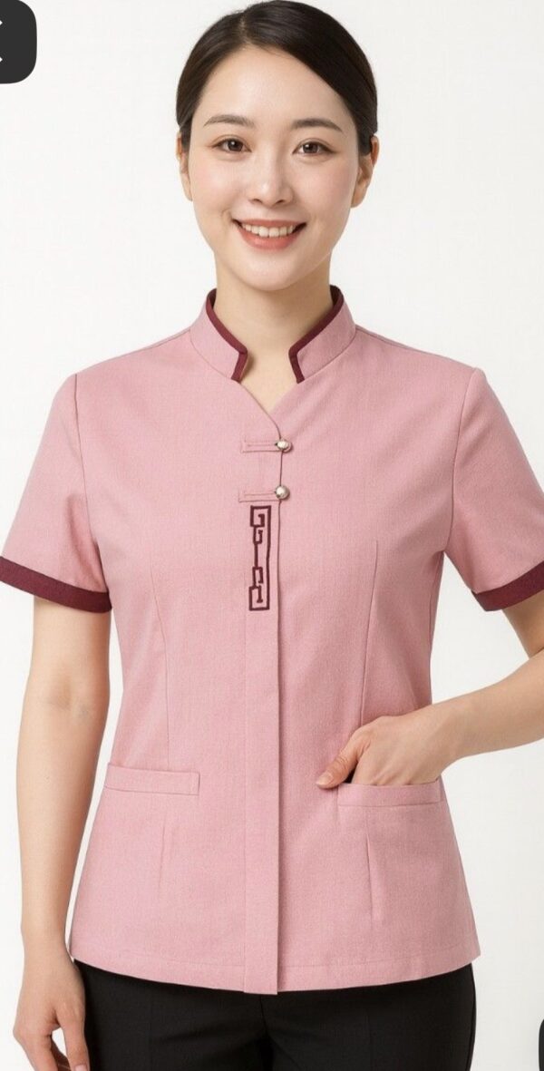 Pink spa uniform with mandarin collar, contrast sleeve trim, and front pocket detailing
